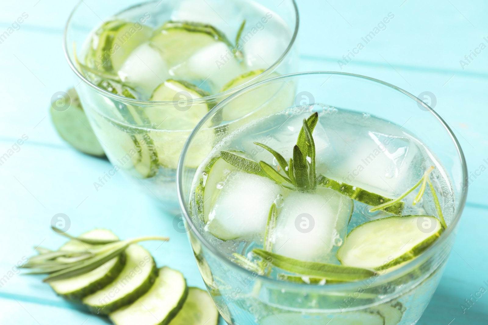 Photo of Natural lemonade with cucumber in glasses on table, closeup