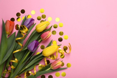 Beautiful colorful tulips, confetti and serpentine streamers on pink background, flat lay. Space for text
