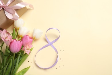 Photo of 8th of March greeting card design with violet ribbon, gift box, beautiful flowers and space for text on beige background, flat lay. International Women's day