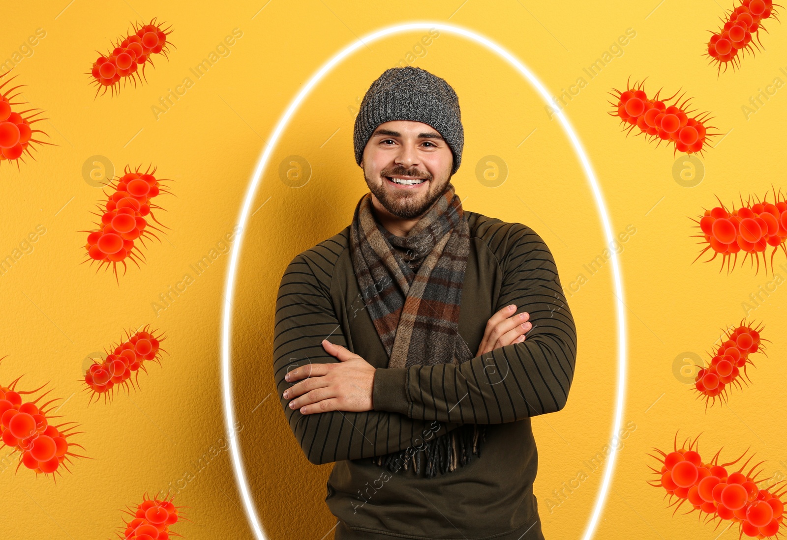 Image of Man with strong immunity surrounded by viruses on yellow background