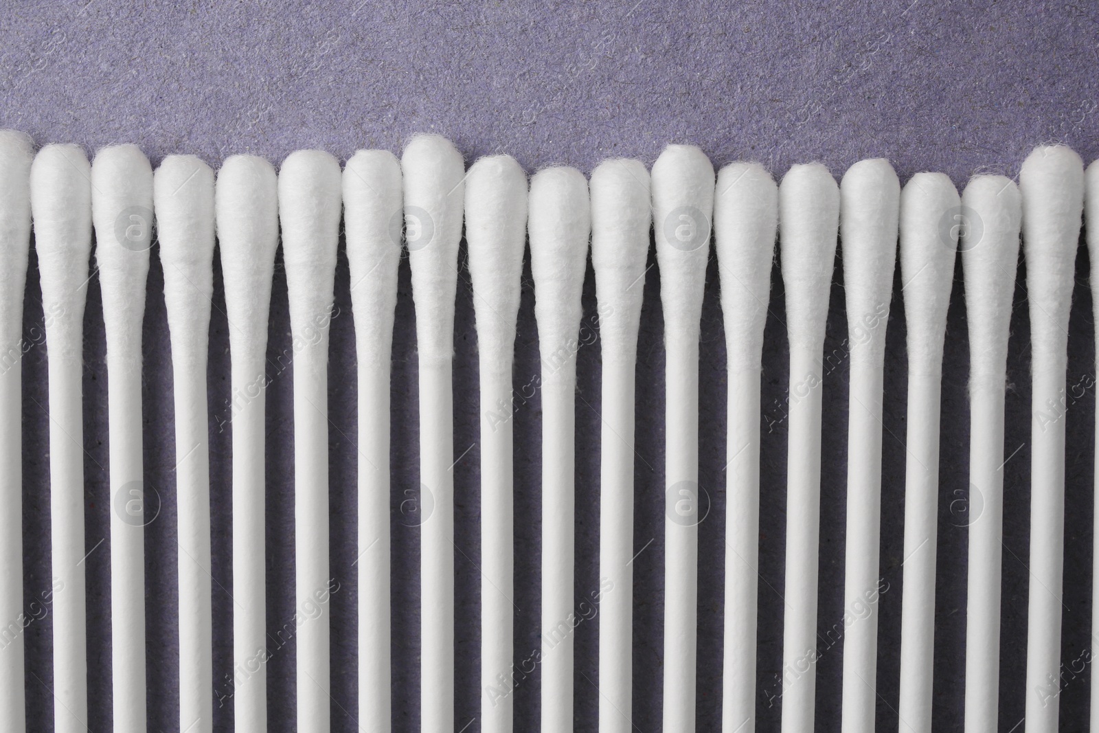 Photo of Many clean cotton buds on blue background, flat lay