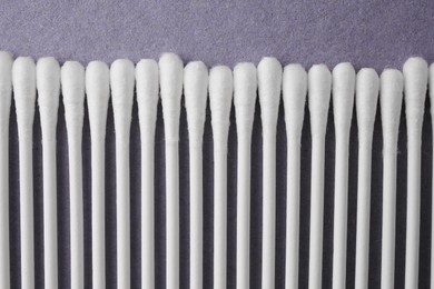 Photo of Many clean cotton buds on blue background, flat lay