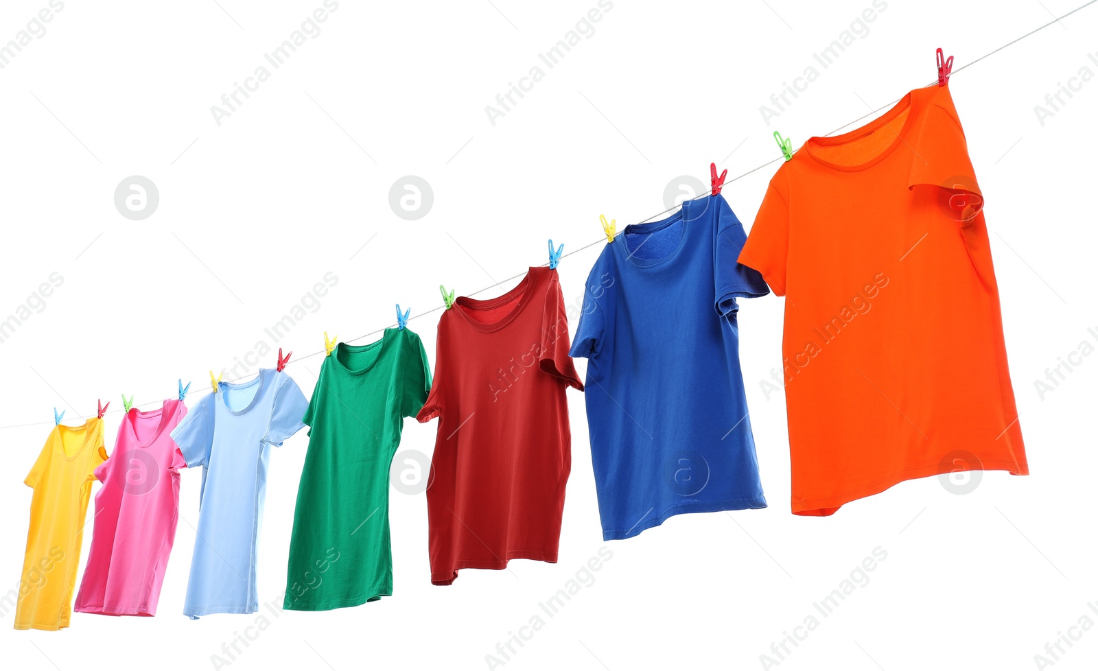 Photo of Colorful t-shirts drying on washing line isolated on white