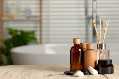 Photo of Composition with spa products on wooden table in bathroom, space for text