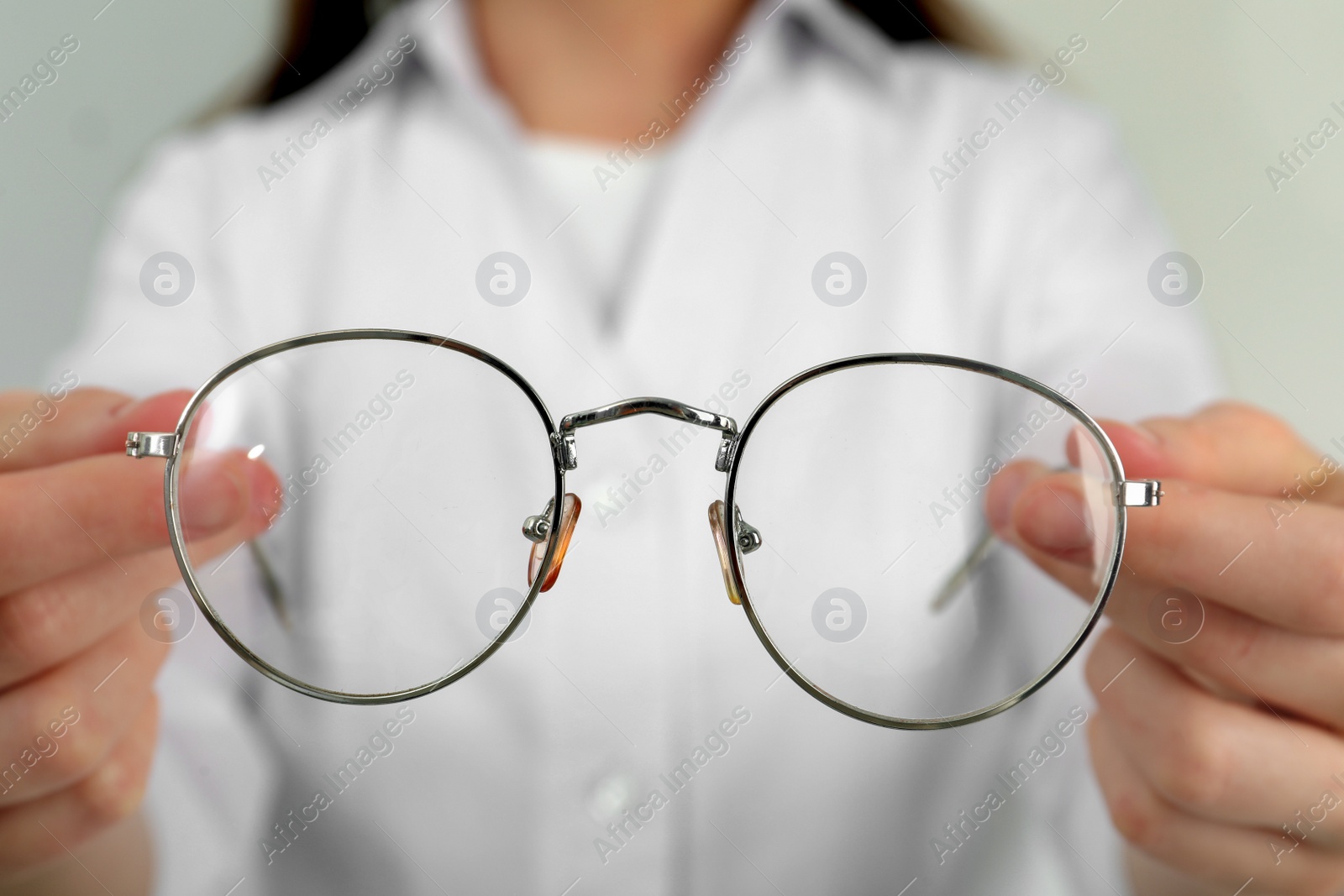 Photo of Woman with glasses on light background, closeup