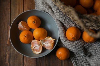 Photo of Fresh ripe tangerines on wooden table, flat lay