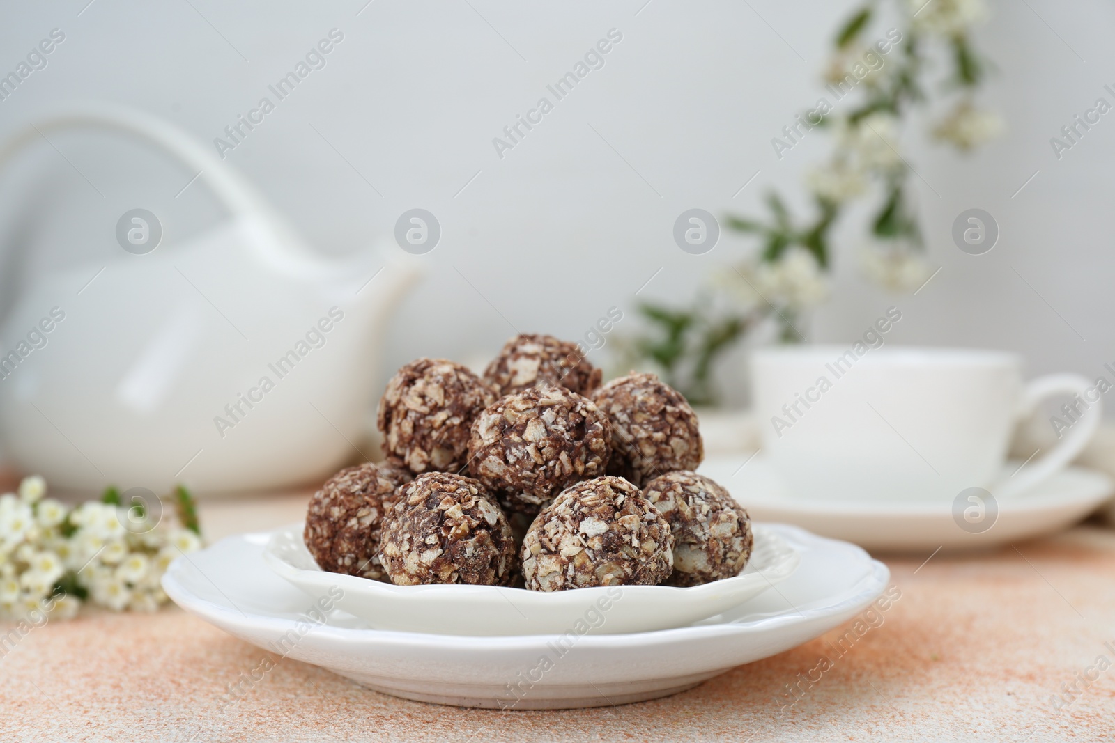 Photo of Delicious sweet chocolate candies on beige table