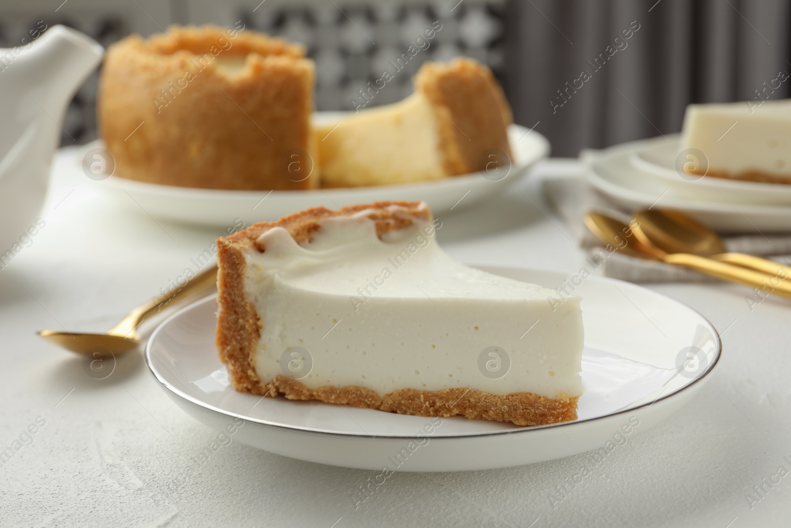 Photo of Piece of tasty vegan tofu cheesecake on white table, closeup