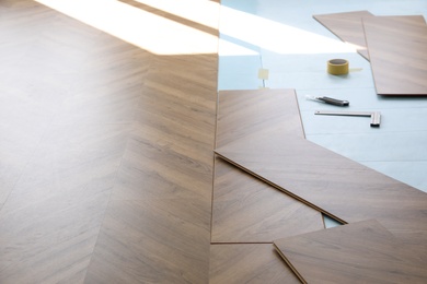 Installation of laminated wooden floor at home