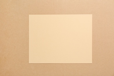 Photo of Piece of cardboard on color background, top view