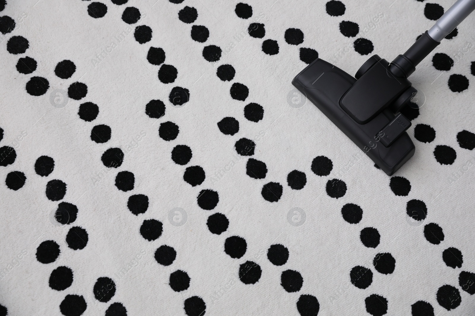 Photo of Modern vacuum cleaner on carpet. Space for text