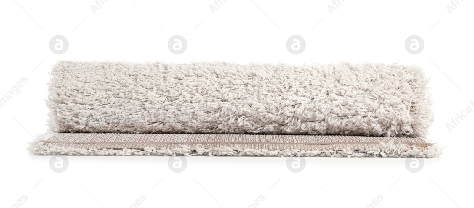 Photo of Rolled fuzzy carpet on white background. Interior element