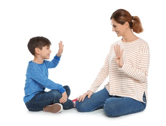 Photo of Hearing impaired mother and her child talking with help of sign language on white background