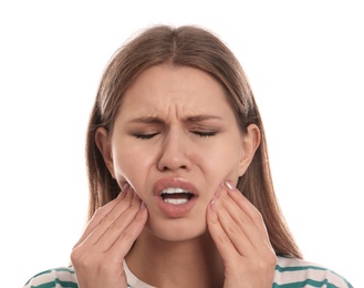 Young woman suffering from toothache on white background