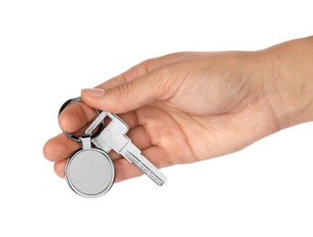 Photo of Woman holding key with metallic keychain on white background, closeup