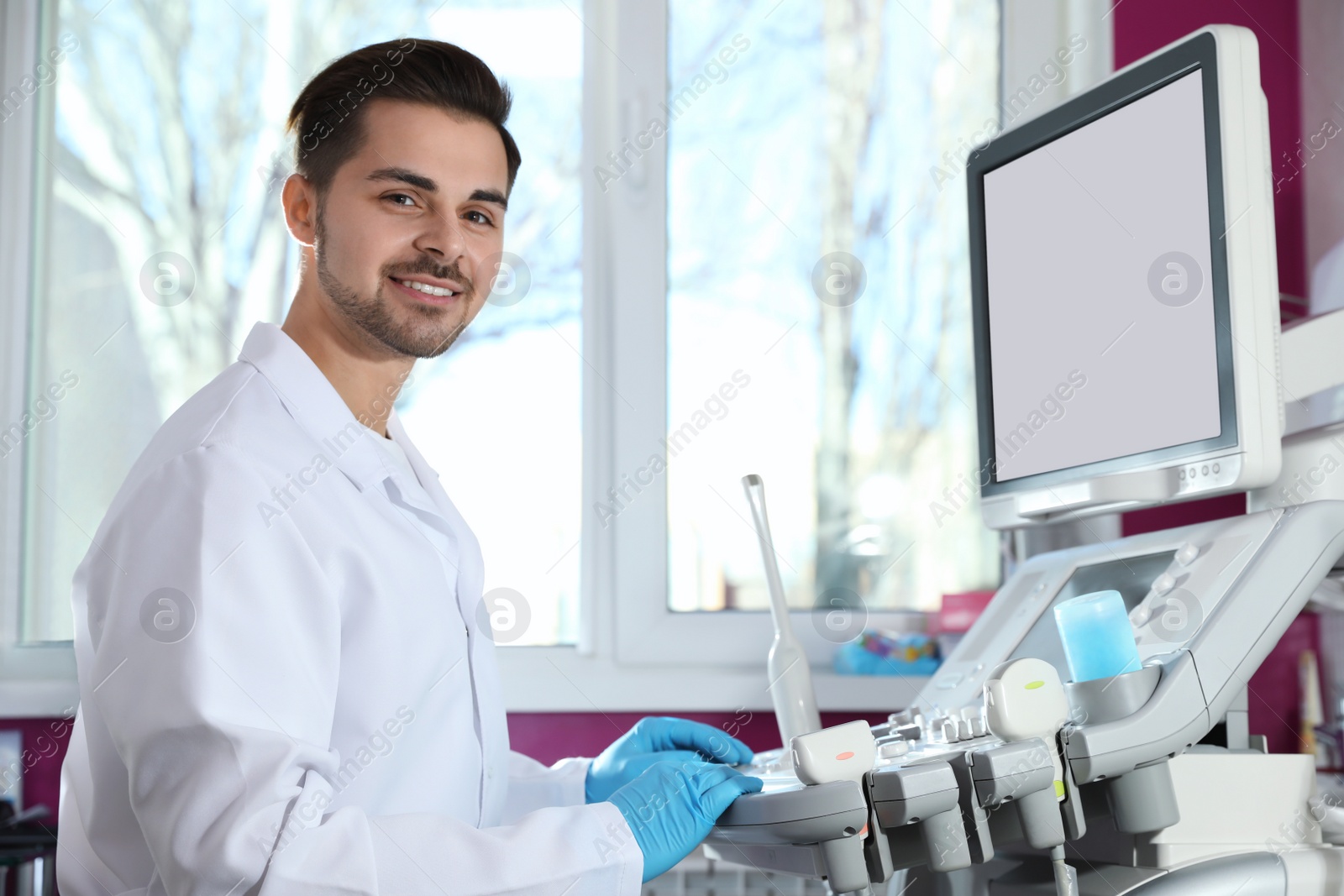 Photo of Sonographer using modern ultrasound machine in clinic