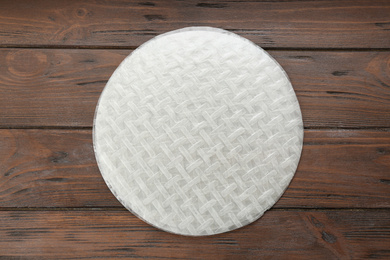Stack of dry rice paper on wooden table, top view