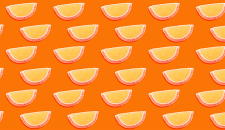 Image of Tasty jelly candies on orange background. Pattern design