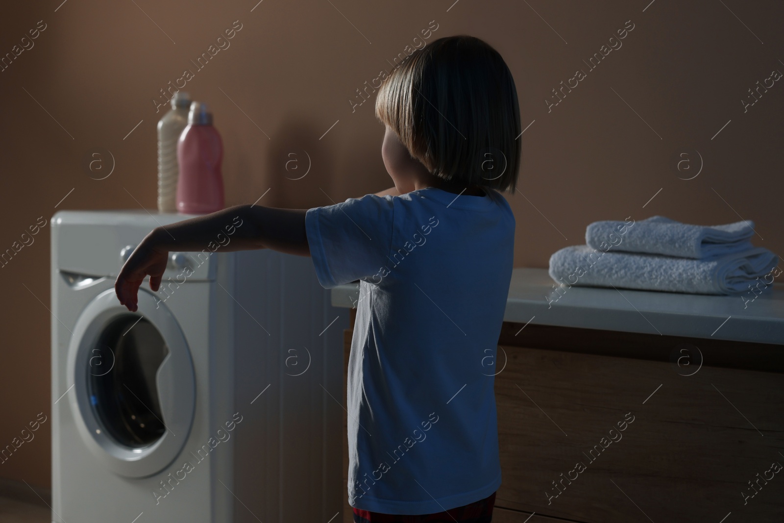 Photo of Boy in pajamas sleepwalking indoors at night