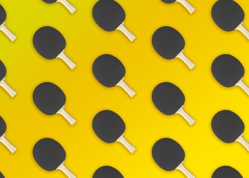 Image of Table tennis paddles on yellow background, flat lay