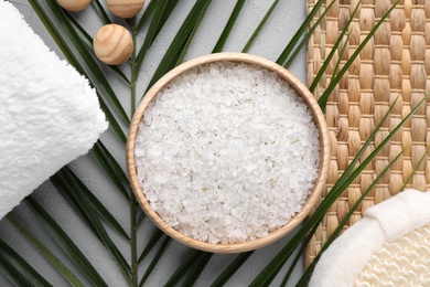 Photo of Flat lay composition with white sea salt on grey background. Spa treatment