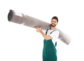 Photo of Young worker carrying rolled carpet isolated on white. Moving service