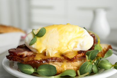 Photo of Delicious egg Benedict with sprouts served on plate