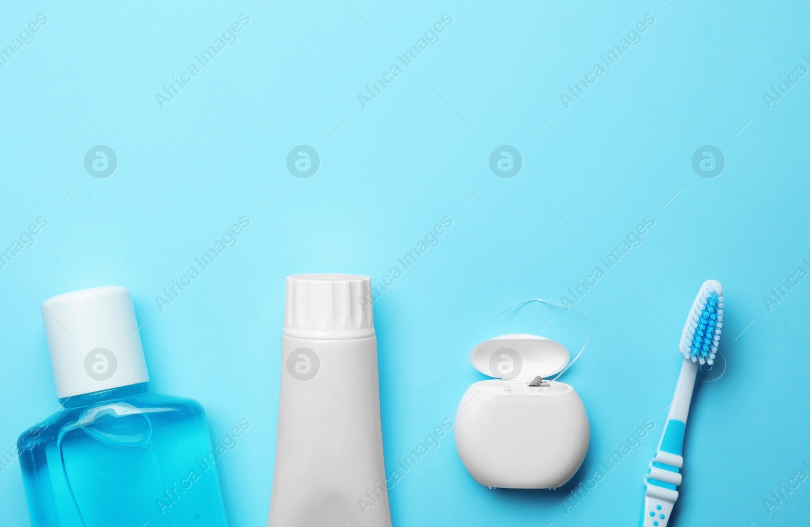 Photo of Flat lay composition with toothpaste, oral hygiene products and space for text on color background