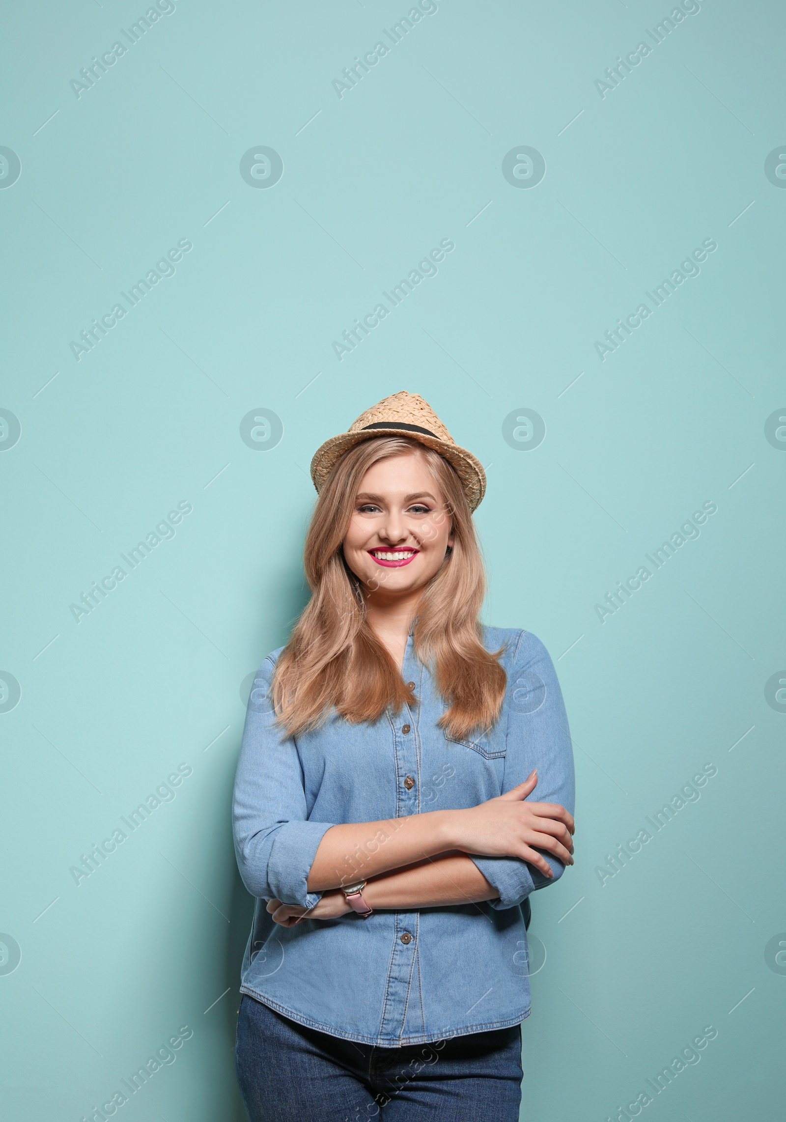 Photo of Attractive young woman in stylish outfit on color background