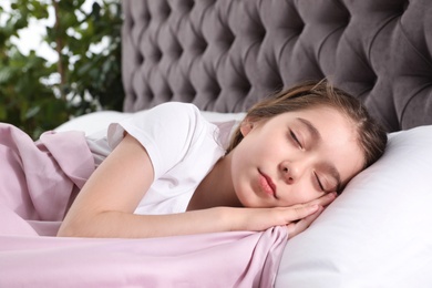 Photo of Beautiful little girl sleeping in bed at home