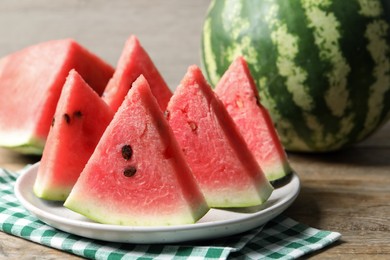 Photo of Delicious fresh watermelon slices on wooden table, closeup