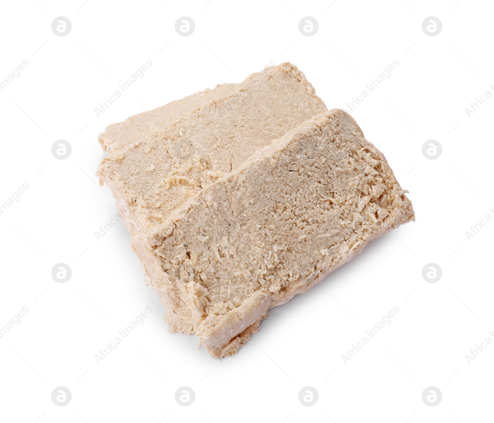 Photo of Pieces of tasty halva isolated on white, above view