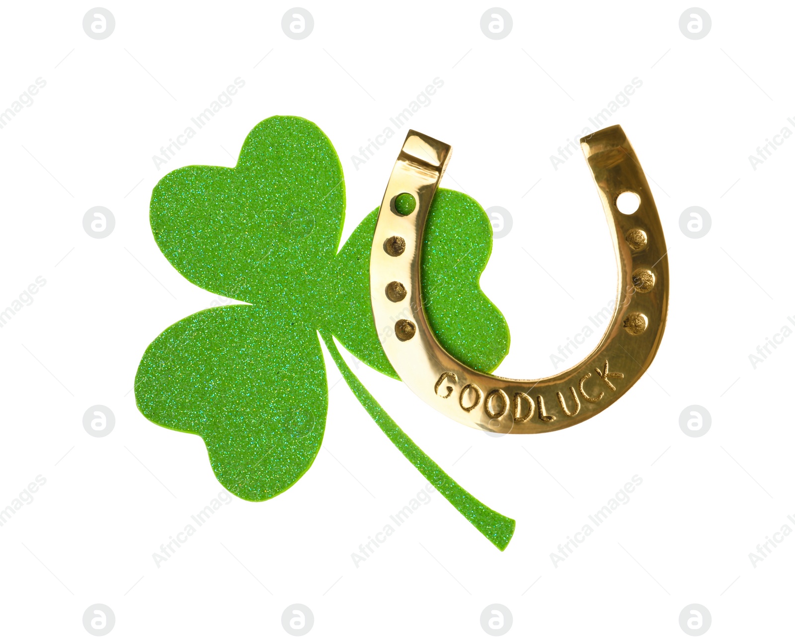 Photo of Golden horseshoe with phrase GOOD LUCK and clover on white background. St. Patrick's Day celebration