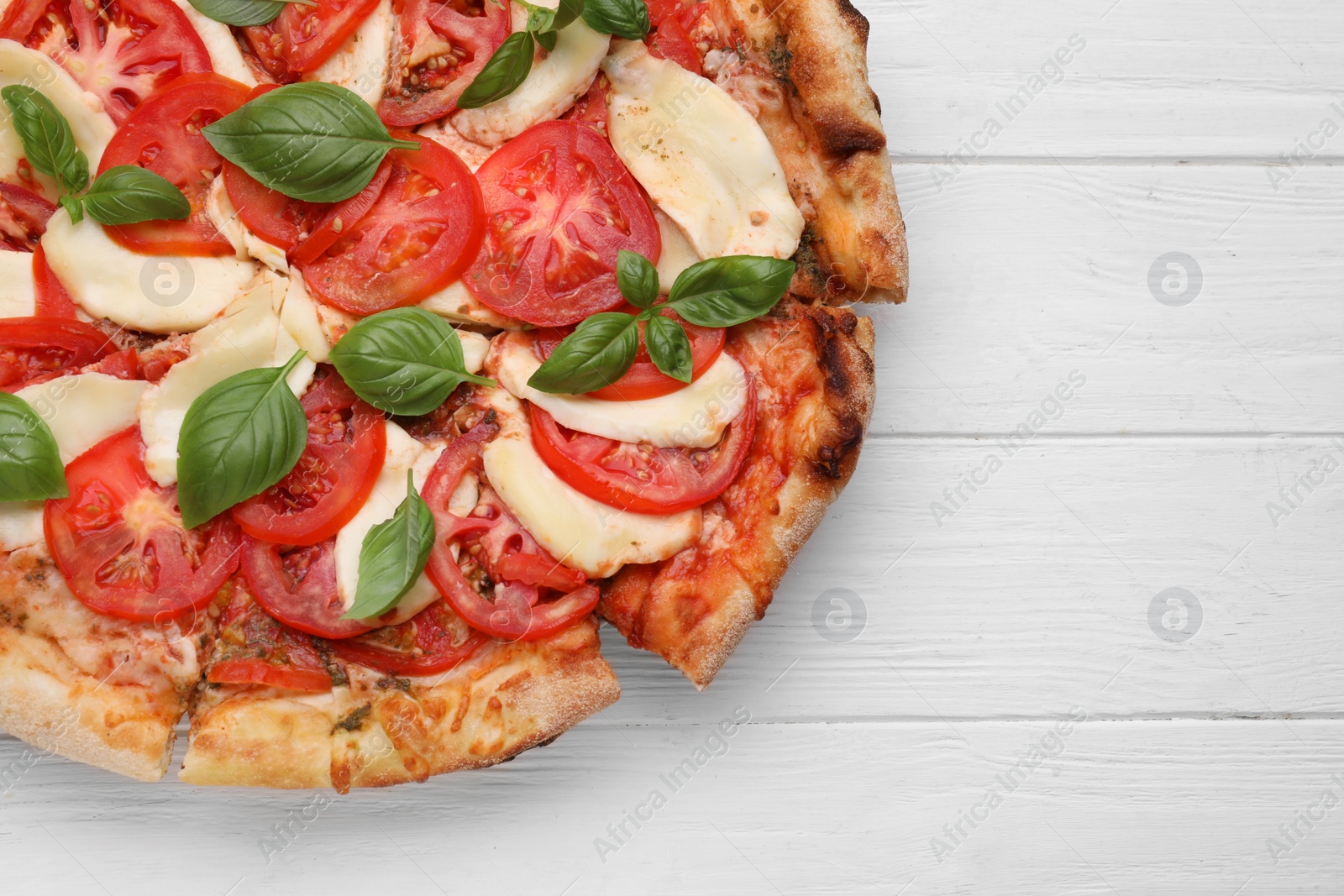 Photo of Delicious Caprese pizza on white wooden table, top view. Space for text