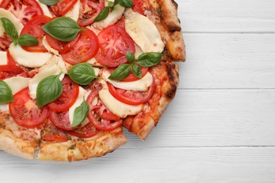 Photo of Delicious Caprese pizza on white wooden table, top view. Space for text