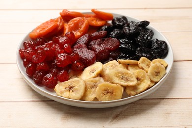 Photo of Delicious dried fruits on white wooden table