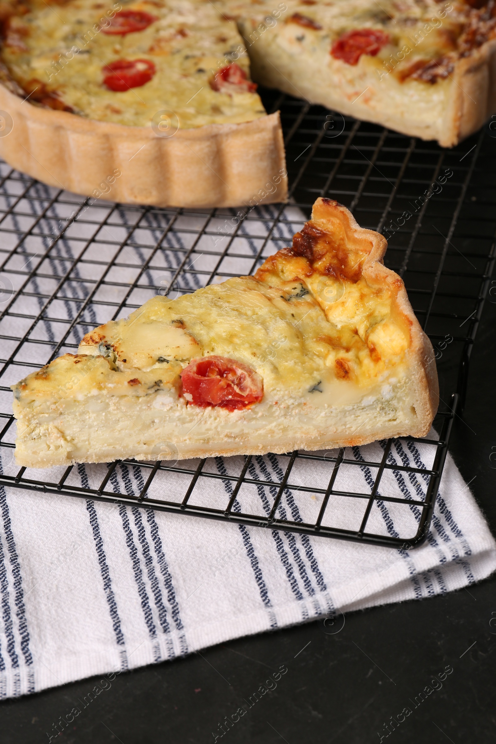 Photo of Delicious homemade cheese quiche on black table