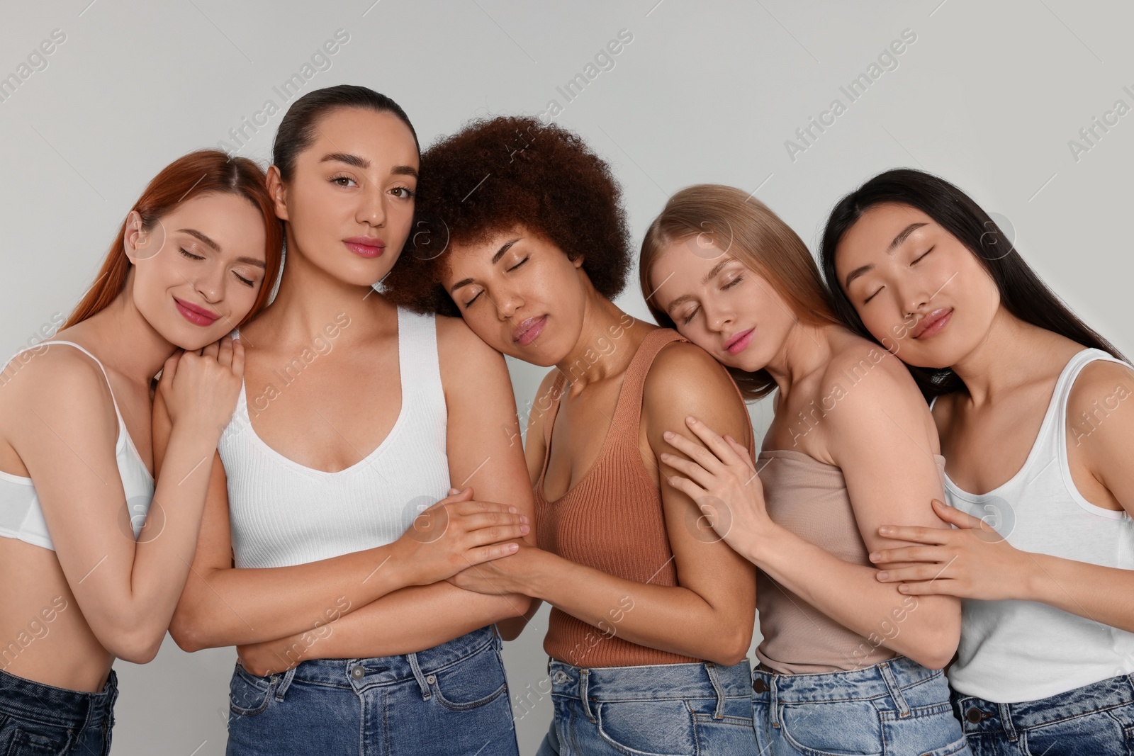 Photo of Portrait of beautiful young women on light grey background