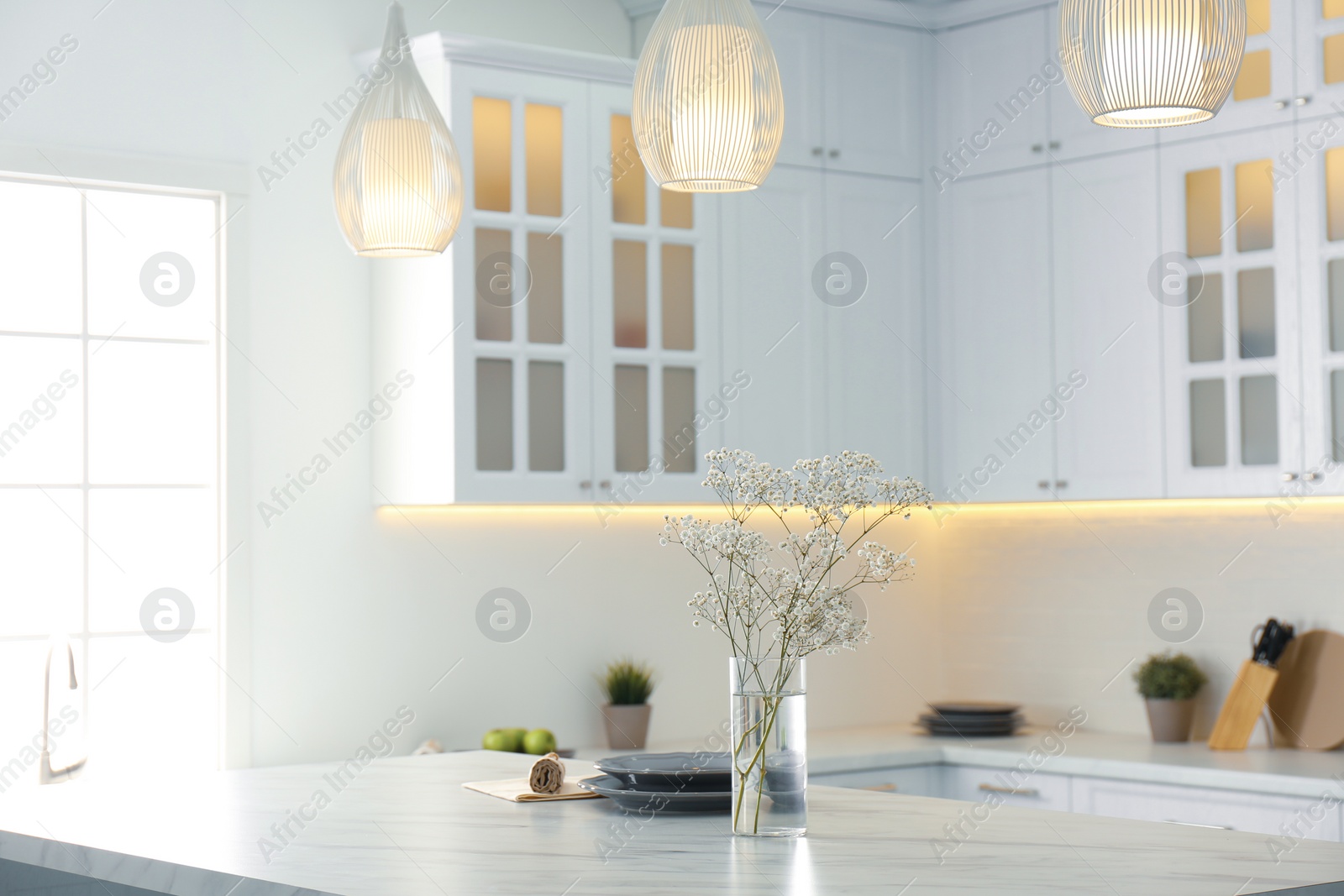 Photo of Beautiful plates and bouquet on table in kitchen