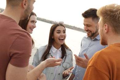 Group of happy people spending time together outdoors