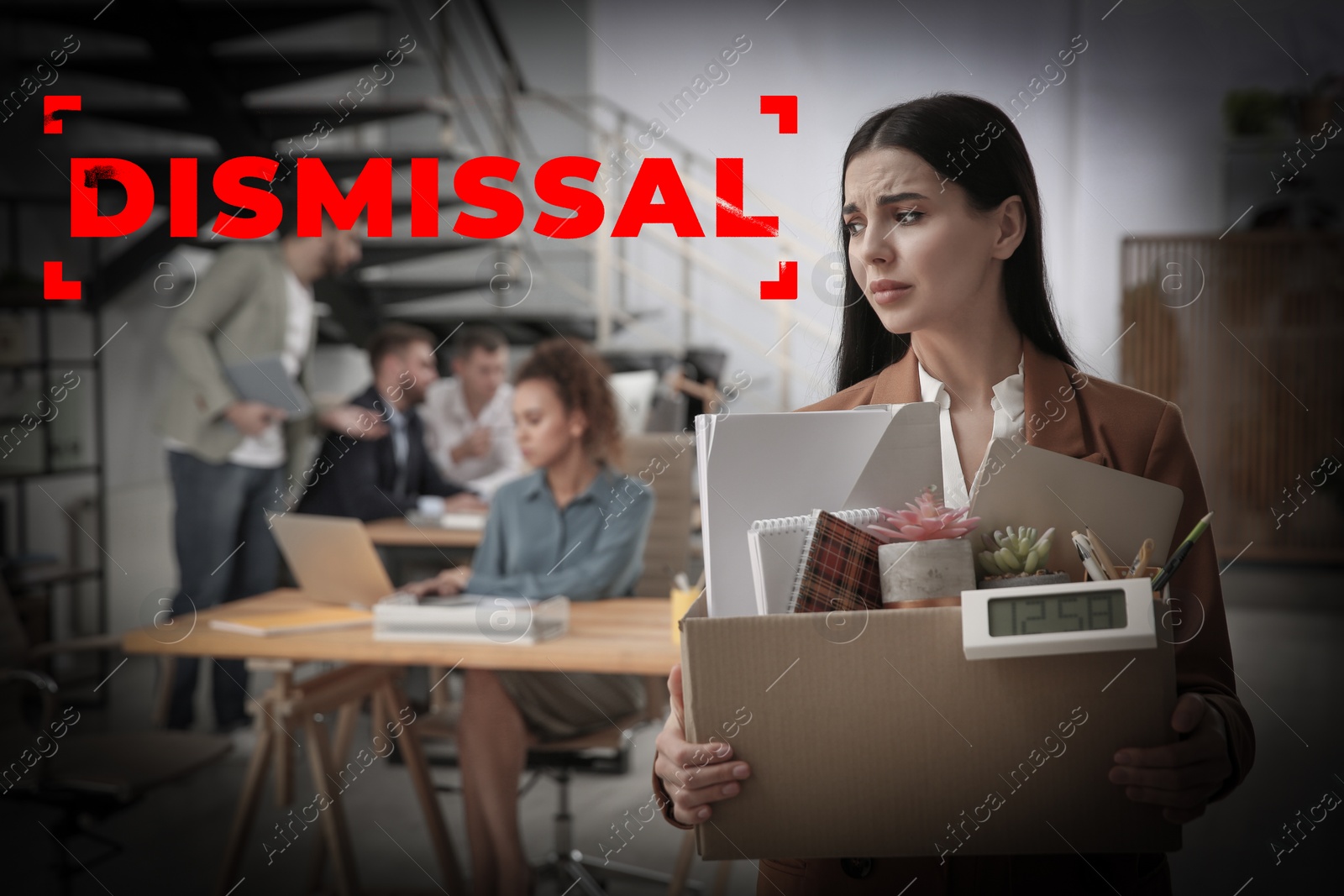 Image of Upset dismissed young woman carrying box with stuff in office