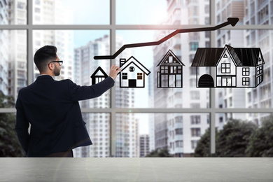 Image of Real estate agent demonstrating prices at housing market. Man pointing on graph illustration
