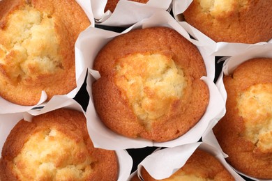 Delicious sweet muffins as background, top view