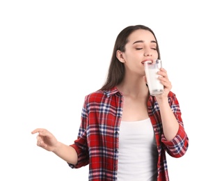 Beautiful young woman drinking milk on white background