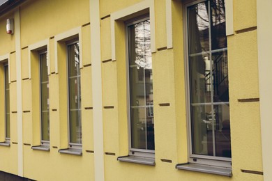 Closeup view of building with stylish grey windows