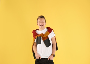 Photo of Portrait of stylish teenage boy on color background