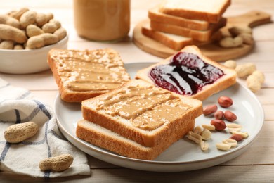 Photo of Delicious toasts with peanut butter, jam and nuts on light wooden table, closeup