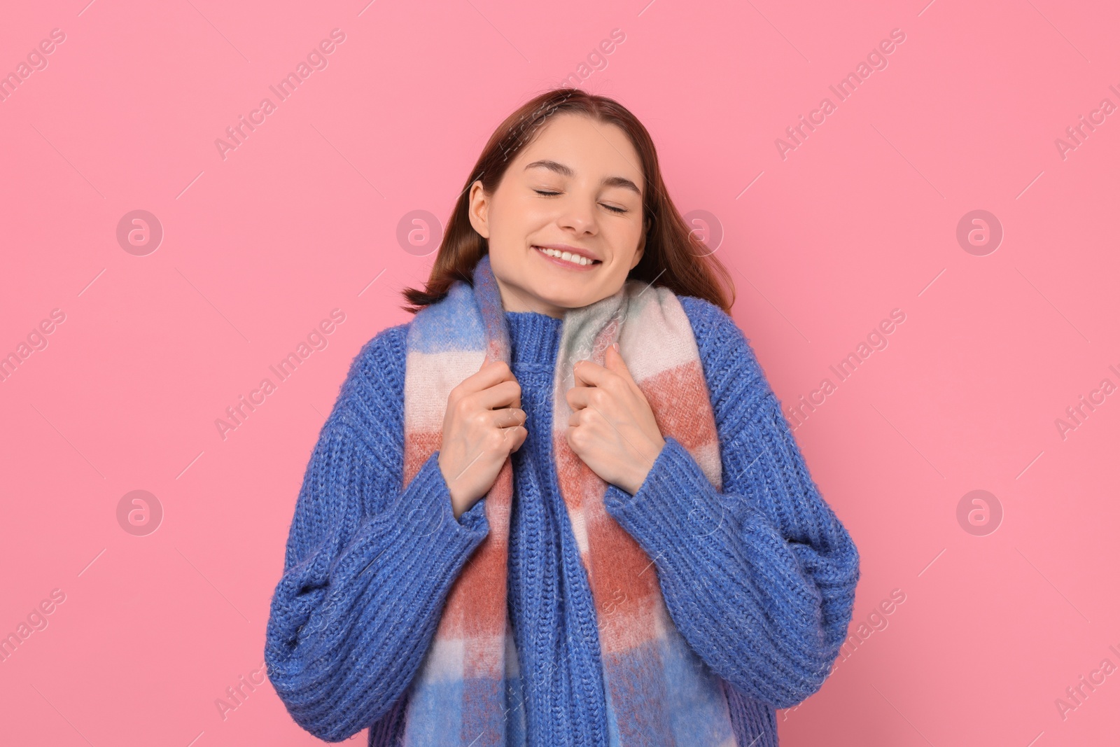 Photo of Beautiful woman in warm scarf on pink background