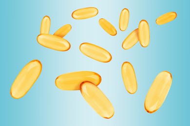 Image of Vitamin. Softgel capsules falling on light blue gradient background