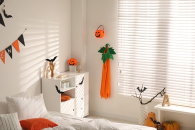 Stylish bedroom interior with festive Halloween decor